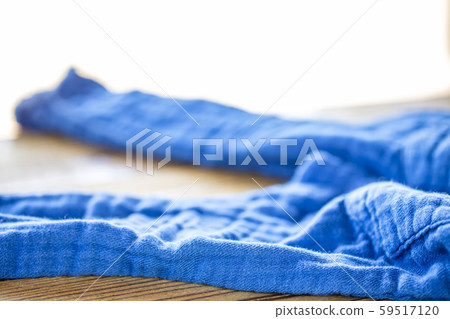 Undressed blue pants on a wooden table Undressed blue pants on a wooden table 59517120