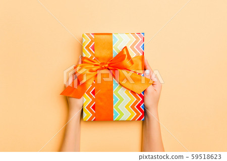 Flat lay of woman hands holding gift wrapped and 59518623