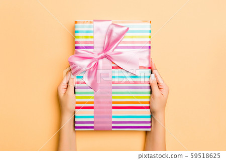 Flat lay of woman hands holding gift wrapped and 59518625