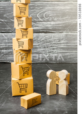Two wooden people stand near a tower of boxes. buyer and seller, manufacturer and retailer. Discussion of the terms of the trading deal, the purchase of goods and services. Business and commerce. Two wooden people stand near a tower of boxes. buyer and seller, manufacturer and retailer. Discussion of the terms of the trading deal, the purchase of goods and services. Business and commerce. 59518698