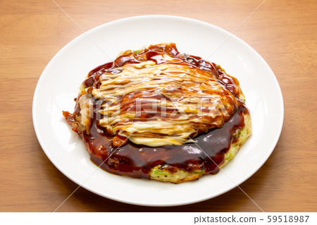Okonomiyaki with plenty of mayonnaise and sauce. Okonomiyaki with plenty of mayonnaise and sauce. 59518987