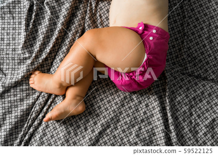Sleeping baby with cloth diaper. Top view. Ecology reusable organic diaper. Copy space 59522125