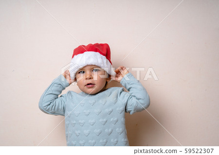 Funny little kid in red hat Santa. Christmas concept. Dancing happily. 59522307