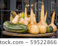 Wooden round table with pumpkins of different 59522866