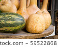 Wooden round table with pumpkins of different 59522868