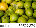 Pile of fresh green yellow limes at market for 59522870