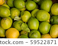 Pile of fresh green yellow limes at market for 59522871