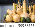 Wooden round table with pumpkins of different 59522873