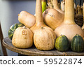 Wooden round table with pumpkins of different 59522874