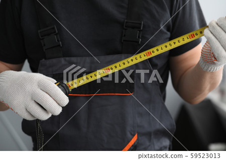 Man holding measuring device Man holding measuring device 59523013