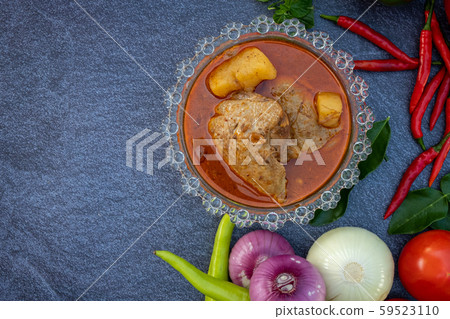 Asian food such as Thai red curry top view with copy space.Vegetables and ingredient are around in good cuisine design on the stone background. Asian food such as Thai red curry top view with copy space.Vegetables and ingredient are around in good cuisine design on the stone background. 59523110