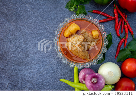 Asian food such as Thai red curry top view with copy space.Vegetables and ingredient are around in good cuisine design on the stone background. Asian food such as Thai red curry top view with copy space.Vegetables and ingredient are around in good cuisine design on the stone background. 59523111