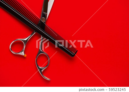 Scissors with a comb close-up. Hairdresser tools. 59523245