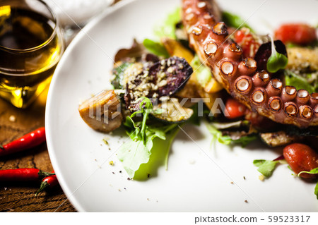 Octopus salad served on a plate in restaurant Octopus salad served on a plate in restaurant 59523317