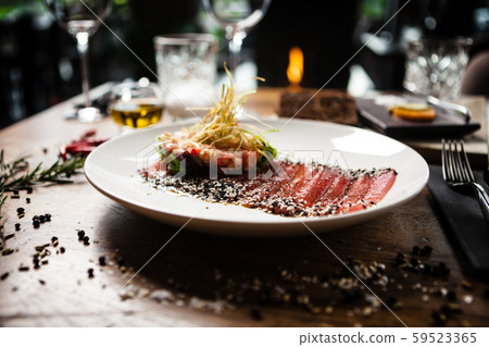 Tuna sashimi served on a plate in restaurant 59523365