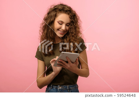 Pretty girl with tablet on pink background 59524648