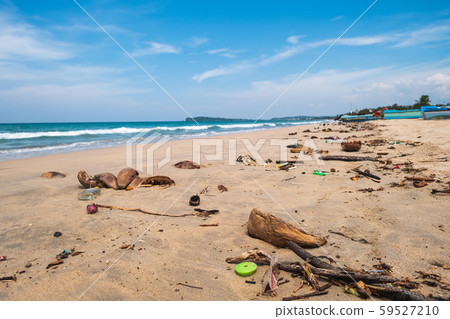 Dirty tropical beach with rubbish on blue sky Dirty tropical beach with rubbish on blue sky 59527210