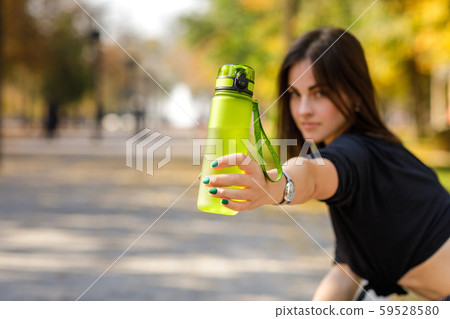 woman holding bottle of water 59528580