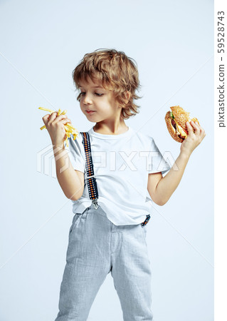 Pretty young boy in casual clothes on white studio background Pretty young boy in casual clothes on white studio background 59528743