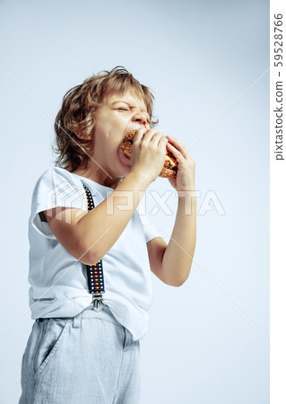 Pretty young boy in casual clothes on white studio background Pretty young boy in casual clothes on white studio background 59528766