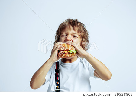 Pretty young boy in casual clothes on white studio background Pretty young boy in casual clothes on white studio background 59528805