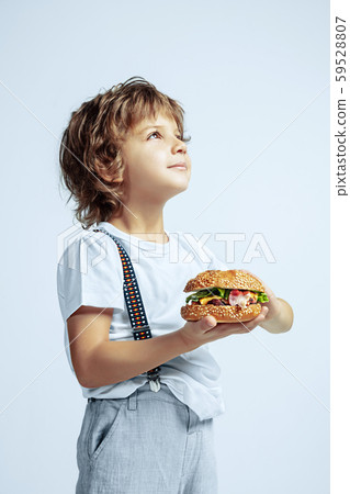 Pretty young boy in casual clothes on white studio background Pretty young boy in casual clothes on white studio background 59528807