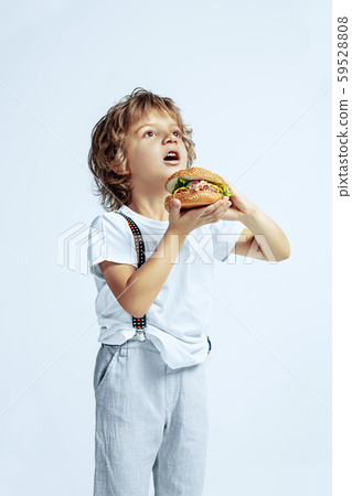 Pretty young boy in casual clothes on white studio background Pretty young boy in casual clothes on white studio background 59528808
