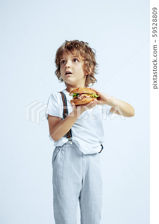 Pretty young boy in casual clothes on white studio background Pretty young boy in casual clothes on white studio background 59528809