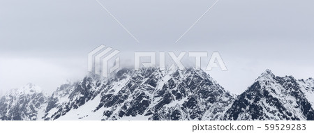 Rocky mountains in snow and overcast grey sky at Rocky mountains in snow and overcast grey sky at 59529283
