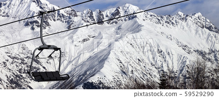 Chair-lift in snow winter mountains at nice sunny 59529290