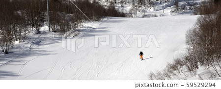 Skier on ski slope at sunny winter day 59529294