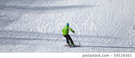 Skier descent on snowy ski slope Skier descent on snowy ski slope 59529301