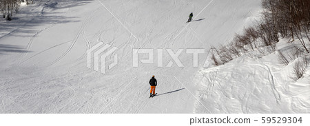 Skiers on ski slope at sun winter day Skiers on ski slope at sun winter day 59529304