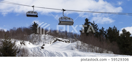 Chair-lift and off-piste slope in ski resort Chair-lift and off-piste slope in ski resort 59529306