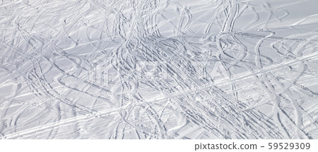 Snowy ski slope with trace from skis and 59529309