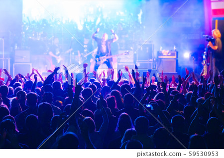 Fans at live rock music concert cheering 59530953