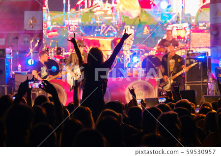 Fans at live rock music concert cheering 59530957