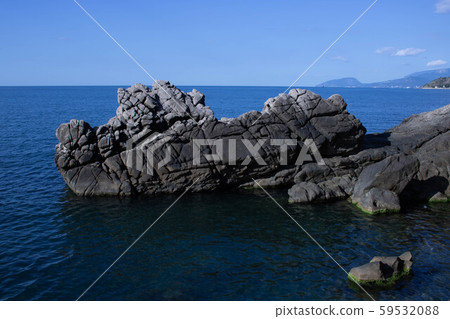 Amazing sunset seascape with rock and sea pebbles, vertical travel background, popular tourist 59532088