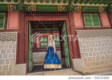 Young caucasian female tourist in hanbok national korean dress at Korean palace. Travel to Korea Young caucasian female tourist in hanbok national korean dress at Korean palace. Travel to Korea 59533980
