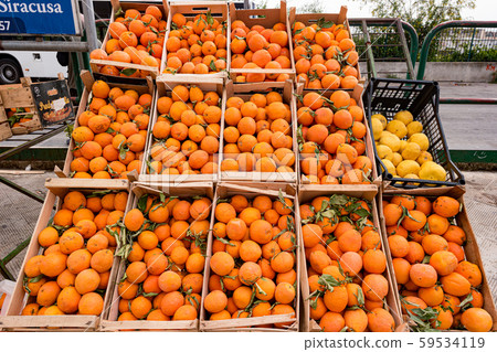 Harvest of oranges in a wooden cart for sale on 59534119