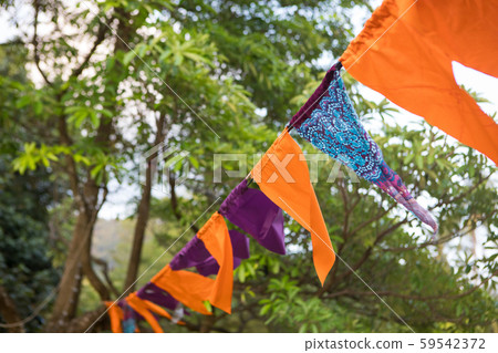 Festive multicolored flags decoration on the beach in the tropics on the background of the sea 59542372