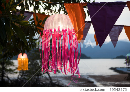 Festive multicolored flags decoration on the beach in the tropics on the background of the sea 59542373