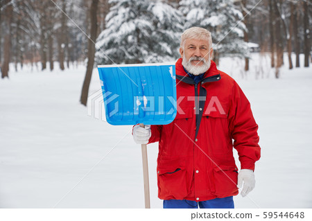 Elderly cleaner posing with shovel outdoors Elderly cleaner posing with shovel outdoors 59544648