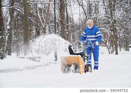 Man cleaning snow with snowblover. Man cleaning snow with snowblover. 59544733