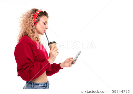 Caucasian girl with curly fair hair drinks coffe, listen to music and talking with friends, portrait Caucasian girl with curly fair hair drinks coffe, listen to music and talking with friends, portrait 59544735