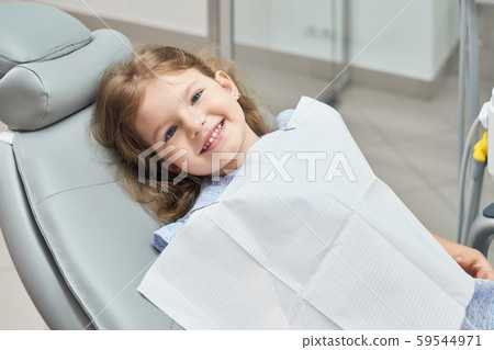 Smiling cute, little child sitting in dental chair. Smiling cute, little child sitting in dental chair. 59544971