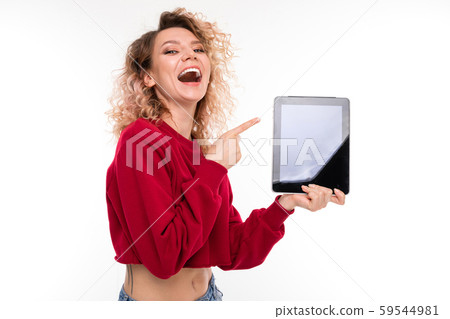 Caucasian girl with curly fair hair holds a tablet and smiles, portrait isolated on white background 59544981