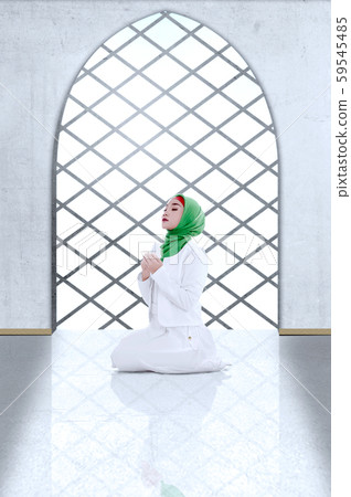 Asian Muslim woman in veil sitting in pray position while raised hands Asian Muslim woman in veil sitting in pray position while raised hands 59545485