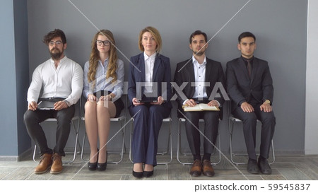 young applicants are awaiting interview. a group of young people bored waiting for job interview young applicants are awaiting interview. a group of young people bored waiting for job interview 59545837