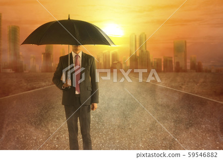 Asian businessman with an umbrella during a heatwave on the city  59546882
